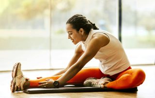 Women in red leggings stretching